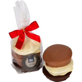 Drei gemischte Lebkuchen in Tütchen aus transparenter Folie mit kleiner roter Schleife