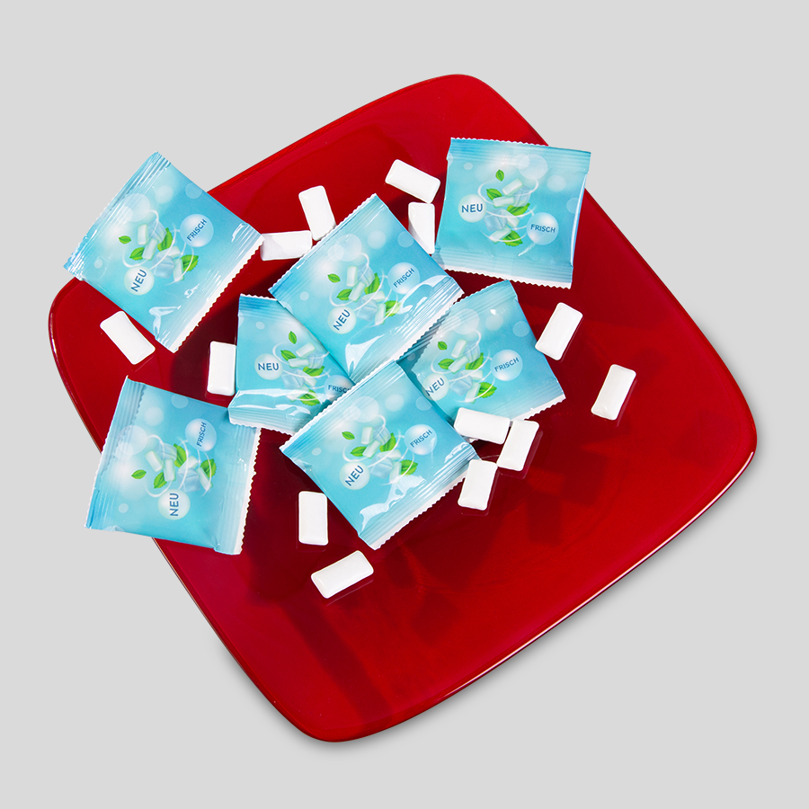 Zuckerfreie Kaugummi-Dragees in einer Schale, mit 4/4-farbig bedruckten Folientütchen